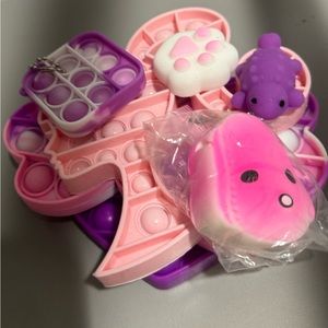 6 purple and pink fidget toys
